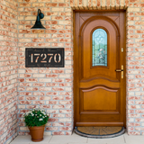 House_Number_Metal_Sign_with_Names_and_L_Black_Brick_Entrance_Mockup.png